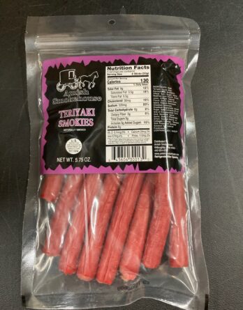 Bag of Amish Smokehouse Teriyaki Smokies; pink and black label with logo, clear window shows red meat sticks inside package.